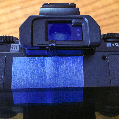 Tape and a ribbon used to hold to OM-D E-M5 eyepiece in place
