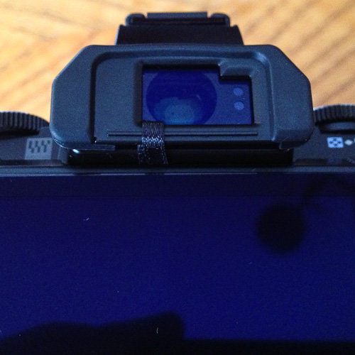 In-use view of the OM-D E-M5 eyepiece retention ribbon