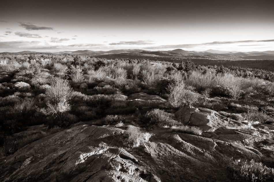 Black and white photo of a mid-autumn sunrise atop Pitcher Mountain in Stoddard, NH