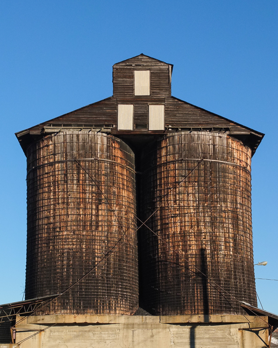Color photo of a dual coal storage silos taken from Emerald Street in Keene, NH