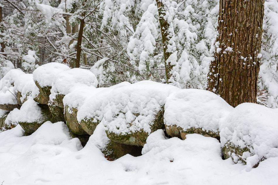 Color photo of snow covering a stone wall