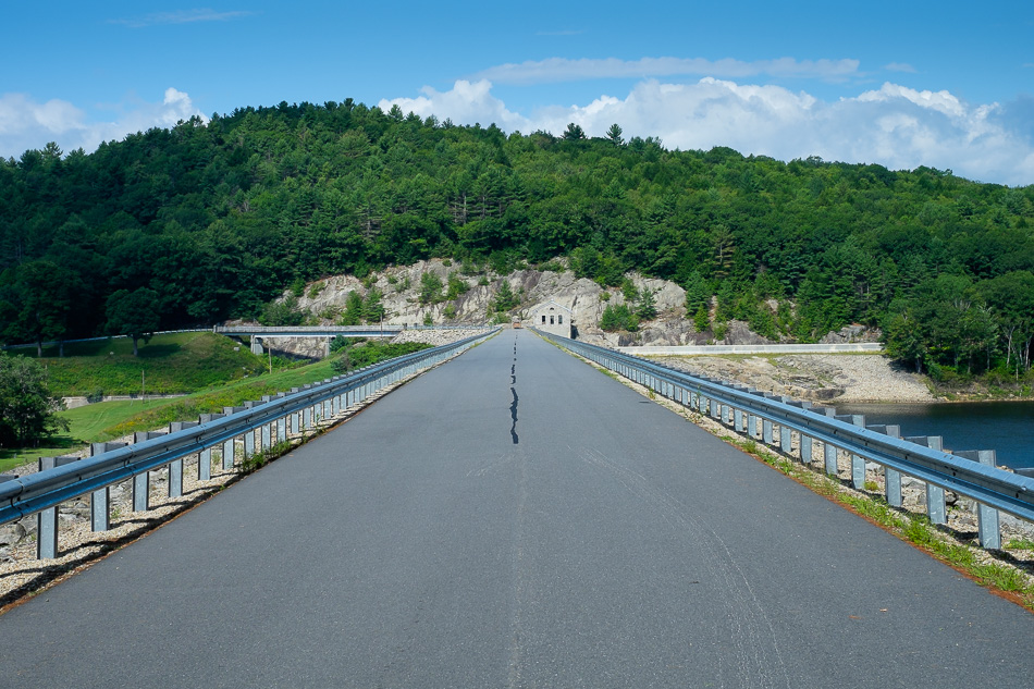 Color photo showing the road that runs across the top of Surry Mountain Dam