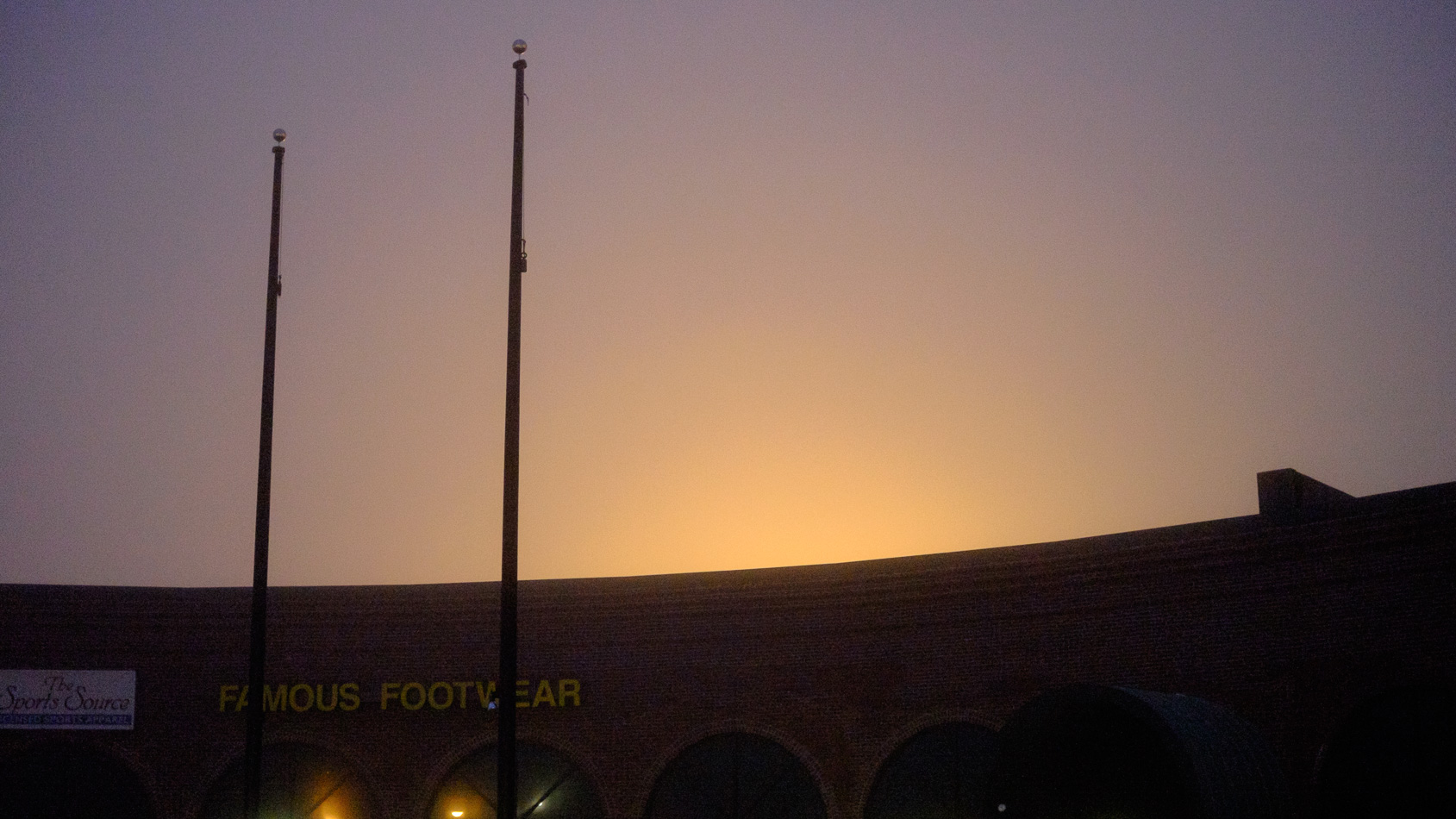 Color photo of the flagpoles at The Center At Keene on a foggy morning
