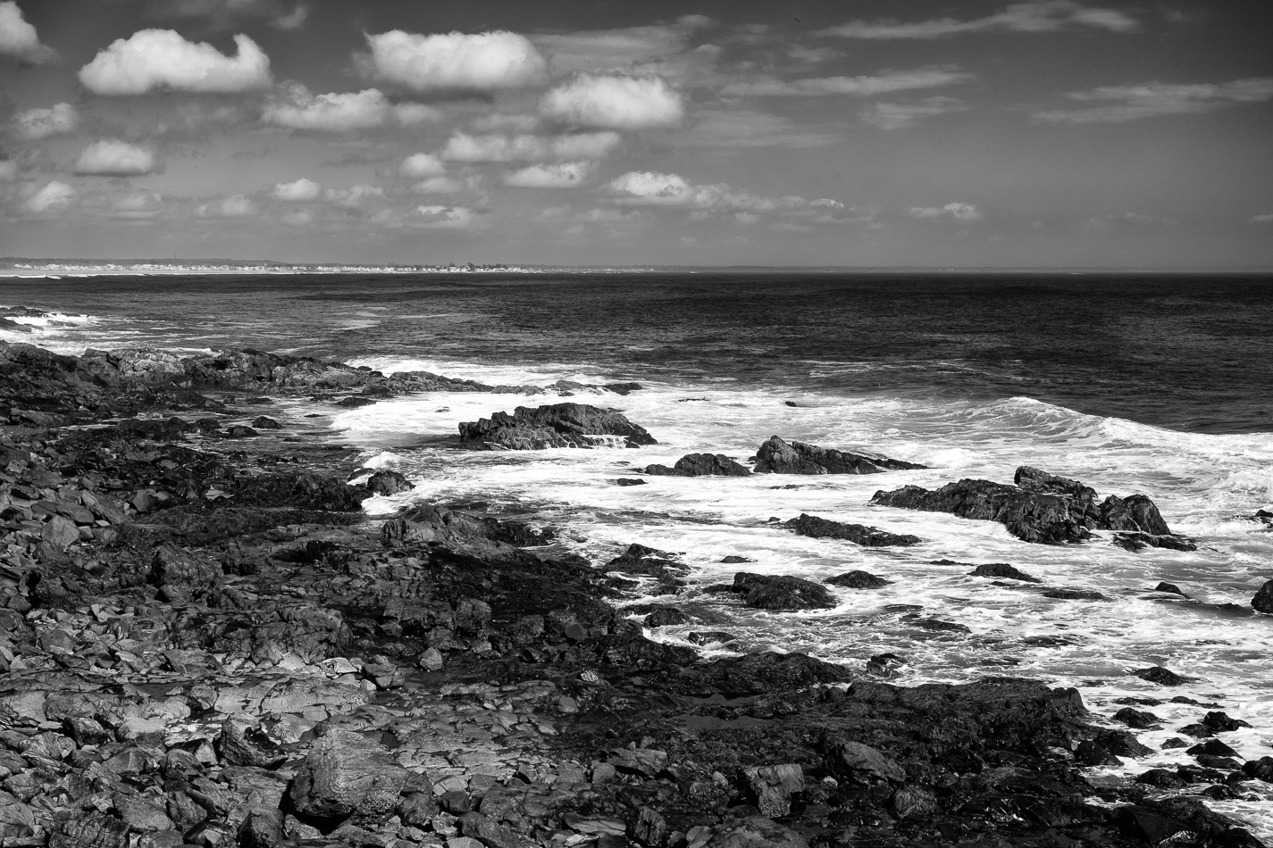 Black and white photo of waves crashing on the rocks along the Marginal Way