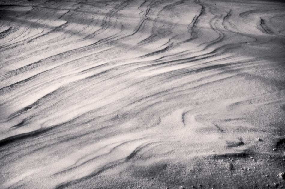 Black and white photo of waves in drifting snow