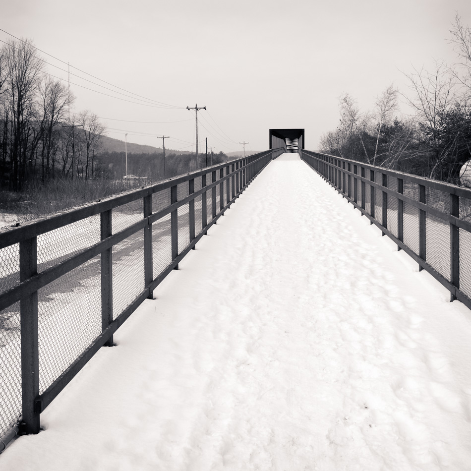 Selenium toned black and white photo of the snow covered North Bridge in Keene, NH