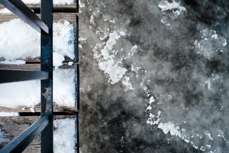 Abstract color photo of the edge of a bridge over an icy river