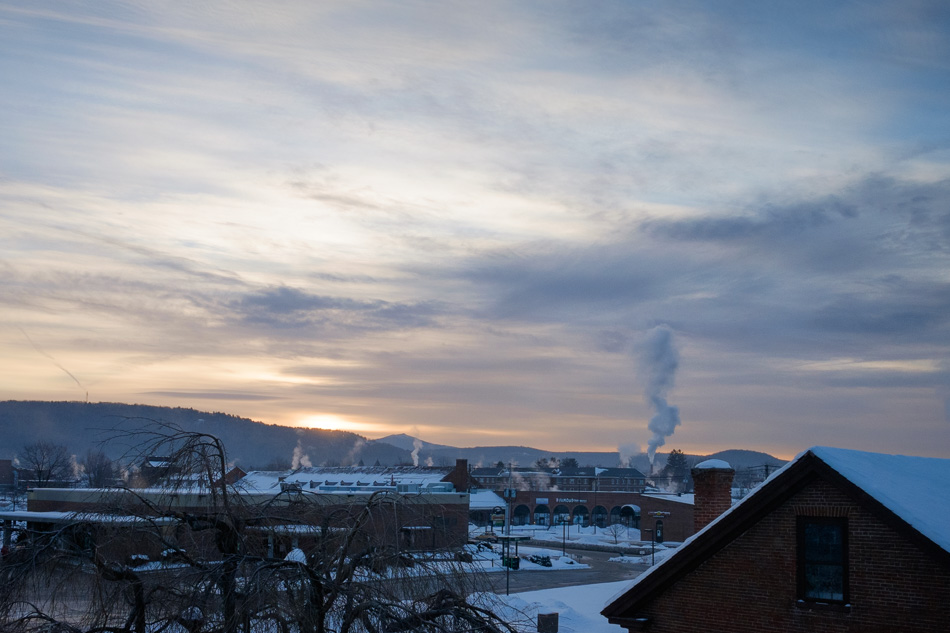 Color photo of smoke rising into an early morning Winter sky