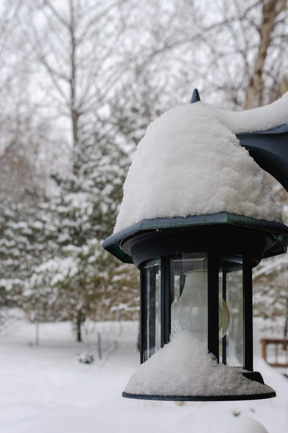 Color photo of fresh snow on a light fixture