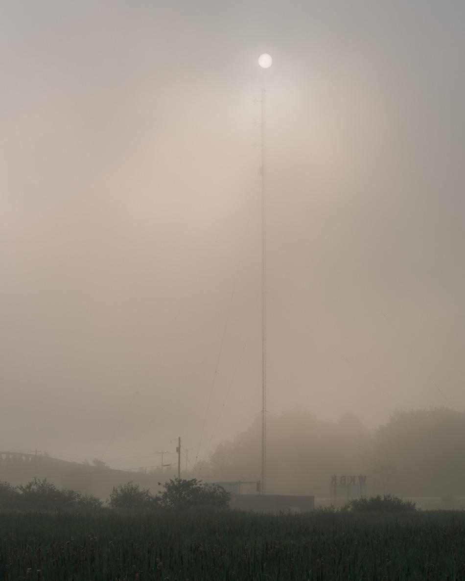 Color photo of the sun resting atop the WKBK antenna in Keene, NH