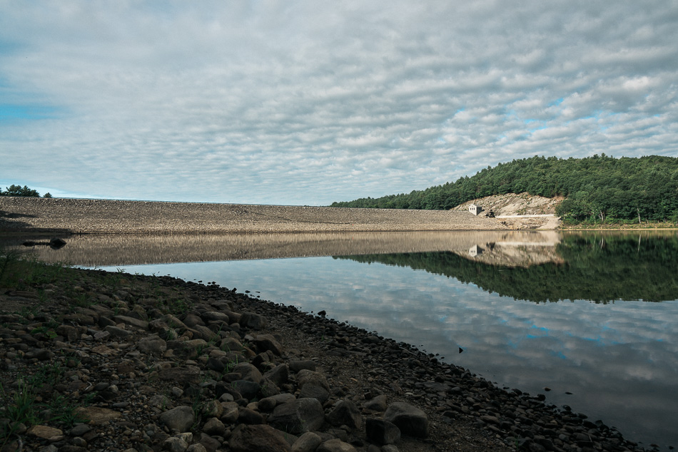 Clouds stream over Surry Dam and the reservoir